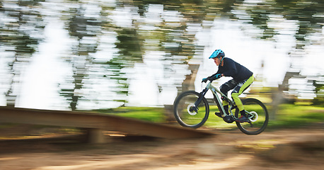 Image showing Bicycle, man and speed with motion blur in forest for sport, race or adventure in summer, woods or nature. Extreme fast cycling, person and action on trail, workout or challenge for fitness on bike