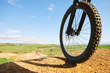 Image showing Cycling, sports and closeup of wheel on bicycle for adrenaline on adventure, freedom and speed. Mountain bike, nature view and cyclist for training, exercise and fitness on dirt road, trail or track