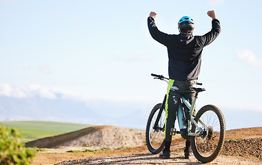 Image showing Cycling, sports and man celebrate on bicycle for winning on adventure, freedom and success. Mountain bike, nature and cyclist cheer for training, exercise and fitness on dirt road, trail or track