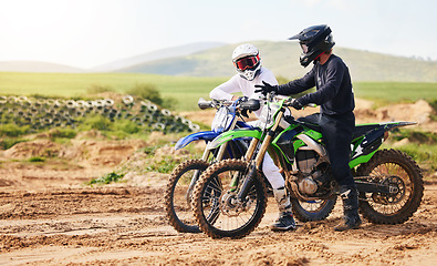 Image showing Sports, friends and men with motorcycle in countryside for fun, hobby and stunt training, practice or freedom. Off road on dirt, motorbike and biker people in nature for adrenaline, challenge or race