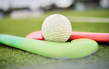 Image showing Hockey, stick and ball on a field for a game, training or exercise for sports. Closeup, ground and gear or equipment for fitness, challenge or a competition on the grass of a park for action