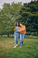 Image showing Women, park and girl friends with phone outdoor with laughing at meme and social media. Urban, city garden and mobile with gen z, young and female people on holiday with freedom and happy in spring