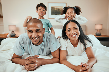 Image showing Happy family, portrait and bonding in bed, having fun and playing in their home together. Face, smile and children with goofy, expression and parents in a bedroom playful, games and enjoying weekend