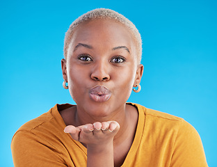 Image showing Blowing kiss, blue background and portrait of black woman with emoji for affection, flirt and love. Happy, beauty and face of female person with hand sign for romance, confidence and relax in studio