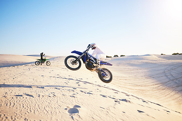 Image showing Motorcycle, desert race and jump in air for competition, stunt and outdoor for performance, goal and speed. Motorbike athlete, dunes and ramp in nature, sand and together for training in mockup space