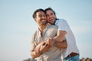 Image showing Love, hug and gay men with blue sky, embrace and smile on summer vacation together in Thailand. Sunshine, romance and marriage, happy lgbt couple relax in nature on island holiday with pride and fun.