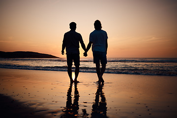 Image showing Silhouette, holding hands and gay men on beach, sunset and shadow on summer vacation together in Thailand. Sunshine, ocean and romance, lgbt couple in nature and fun holiday with pride, sea and sand.