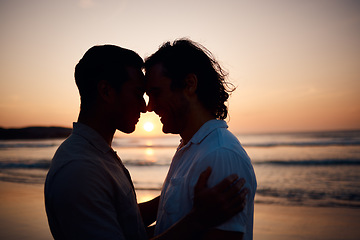 Image showing Sunset, embrace and gay men on beach, silhouette and love on summer vacation together in Thailand. Sunshine, ocean and romance, lgbt couple hug in nature and fun holiday with pride, sea and waves.