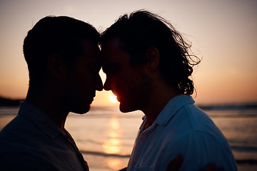 Image showing Beach, sunset and gay couple in silhouette, embrace and love on summer island vacation together in Thailand. Sun, ocean and romance, lgbt men in nature and relax on holiday with pride, sea and light.