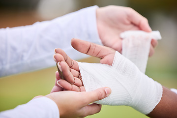 Image showing Sports, bandage and person with hand injury support, first aid emergency and strain after game, competition or workout. Closeup, accident and medic helping athlete with gauze, wound or anatomy trauma