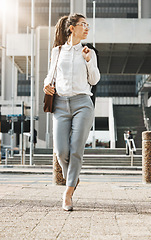 Image showing City, walking and business woman on a sidewalk with travel, commute and urban journey. Road, outdoor and female professional in the morning traveling for work, career and job in New York on street