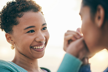 Image showing Lesbian, holding hands or gay couple kiss with love or pride in LGBTQ community with smile or support. Friends, women or happy people in nature on a romantic date or commitment on holiday vacation