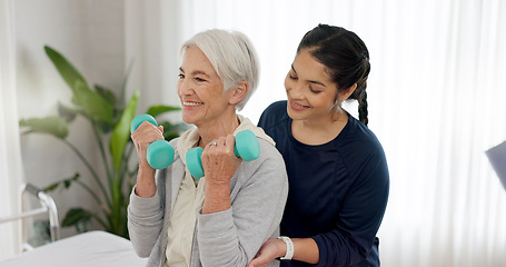 Image showing Woman, nurse and dumbbell with senior patient in physiotherapy, exercise or workout at old age home. Female doctor caregiver or personal trainer helping in elderly care, weightlifting or healthy body