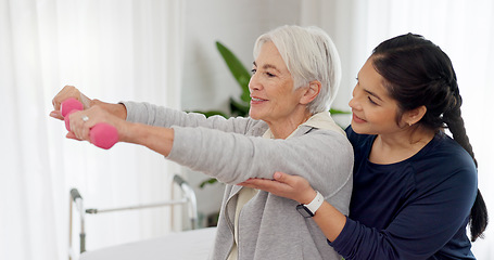 Image showing Woman, nurse and dumbbell with senior patient in physiotherapy, exercise or workout at old age home. Female doctor caregiver or personal trainer helping in elderly care, weightlifting or healthy body