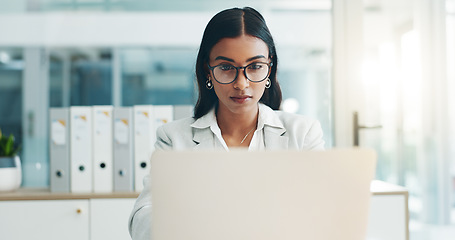 Image showing Business woman, glasses and working on laptop in office for planning, reading email and internet research in law firm. Indian lawyer, attorney and focus at computer to start legal analysis in company