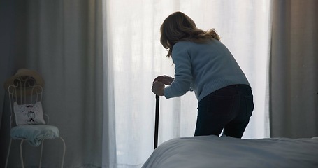 Image showing Balance, medical and window with old woman and walking stick in bedroom for wellness, retirement and healthcare. Depression, mental health and nursing home with patient with a disability for support