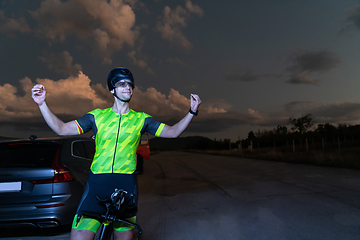 Image showing Triathlete in professional gear running early in the morning, preparing for a marathon, dedication to sport and readiness to take on the challenges of a marathon.