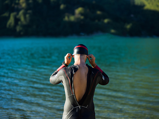 Image showing A triathlon swimmer preparing for a river training to gear up for a marathon