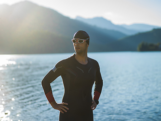 Image showing A triathlon swimmer preparing for a river training to gear up for a marathon