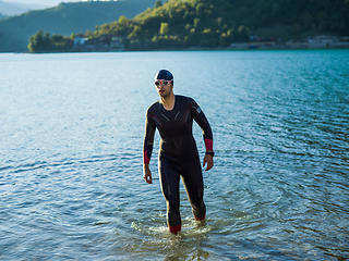 Image showing A triathlon swimmer preparing for a river training to gear up for a marathon