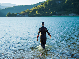 Image showing A triathlon swimmer preparing for a river training to gear up for a marathon