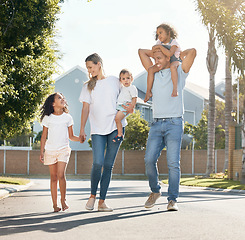 Image showing Happy family, parents walking or children on road in neighborhood with support, care or love. Piggyback, interracial or dad on street to enjoy bonding together in nature with mom, kids or siblings