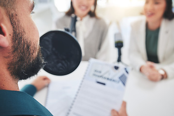 Image showing Man, radio presenter and documents on microphone, reading or interview women for finance advice on show. Podcast, recording and business people speech with paperwork, script or information in studio