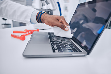 Image showing Man, hands and scientist cleaning laptop in disinfection, bacteria or germ removal in the laboratory. Closeup of male person wiping computer keypad for clean hygiene, sanitizing or health and safety