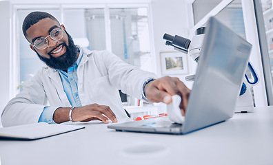 Image showing Wiping keyboard, research and a scientist or man in a lab, working and disinfectant for a laptop. Happy, healthcare and a doctor or an employee cleaning a computer of a virus for medical safety