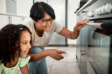 Image showing Baking, oven and a senior woman with her grandchild in the kitchen of a home together for cooking. Family children and an elderly grandmother with a female kid in the house for learning or growth