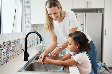 Image showing Mother, child and washing hands at kitchen sink at home for good hygiene, health and wellness. A woman and kid or daughter learning skin care, cleaning and safety from germs or dirt at family house