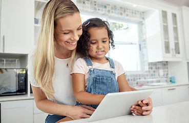 Image showing Blended family, adoption and a mother with her daughter on a tablet in the kitchen for education or study. Children, diversity and learning with woman teaching her girl kid in their home together