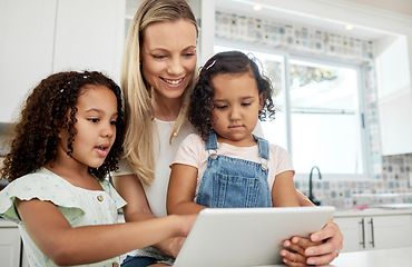 Image showing Blended family, adoption and a mother with her kids on a tablet in the kitchen for education or learning. Sister, diversity and study with woman teaching her girl daughters in their home together