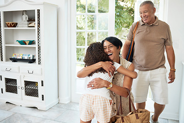 Image showing Visit, home and girl hug grandparents by door excited for bonding, spending time and relationship. Family, happy and grandmother, grandfather and child embrace for greeting, welcome and arrival