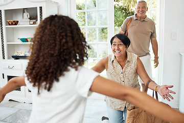 Image showing Hello, home and girl running to grandparents by door excited for bonding, spending time and relationship. Family, happy and grandmother, grandfather and child embrace for greeting, welcome and visit