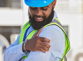 Image showing Black man, engineer or hand on shoulder pain, injury accident or muscle tension on rooftop. Hurt, stress or injured male contractor with sore arm, ache and joint inflammation at construction site