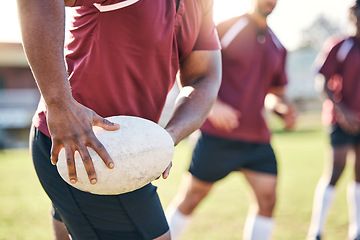 Image showing Hands, rugby and ball with a team on a field together for a game or match in preparation of a competition. Fitness, sports and teamwork with a group of men outdoor on grass for club training