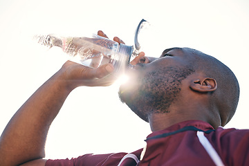 Image showing Black man, drinking water and health with fitness, athlete and sports with hydration and sunshine. African male person, beverage in bottle and wellness with exercise, lens flare and low angle