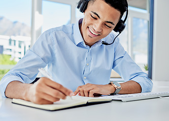 Image showing Smile, call center and a man with a notebook for planning, telemarketing agenda or consulting notes. Happy, office and a customer service employee writing a strategy for online support or advice