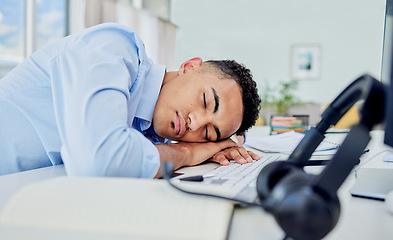 Image showing Call center, tired and man sleeping on desk in a workplace, employee and insomnia with mental health. Business, fatigue and consultant with burnout, tech and exhausted with nap at work with stress