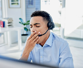 Image showing Tired, yawn and a man in a call center for customer service or support while working online at his desk. Contact us, consulting and crm with an exhausted young male employee in a telemarketing office