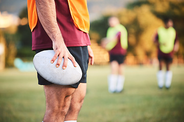 Image showing Rugby, man and closeup with ball for sports games, competition and contest on field. Hands of athlete, person and outdoor training at stadium for fitness, exercise and performance challenge on pitch