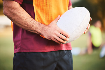 Image showing Rugby, man and hands with ball for outdoor games, competition and contest on field. Closeup of athlete, sports player and match at stadium for fitness, exercise and performance challenge on pitch