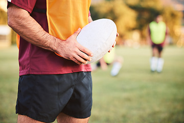 Image showing Rugby, man and hands with ball for sports games, competition and contest on field. Closeup of athlete, team player and training at stadium for fitness, exercise and performance of challenge outdoor