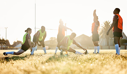 Image showing Sports, fitness and a rugby team stretching on a field at training in preparation for a game or match together. Exercise, teamwork and warm up with an athlete group getting ready for practice