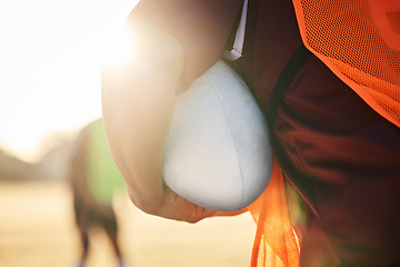 Image showing Rugby, sports and hands on ball in exercise, workout or training outdoor at field lens flare. American football, fitness and man ready to start practice in game, competition or match for body health