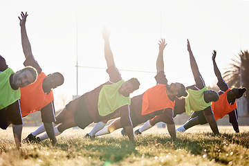 Image showing Rugby, fitness and team at training for competition or morning match doing warm up exercise on grass. Wellness, teamwork and group of players stretching or workout together in professional sports