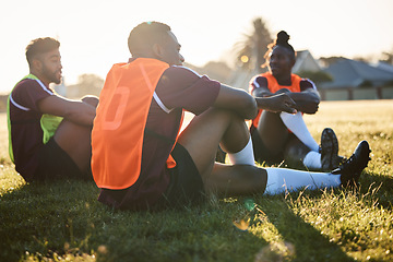Image showing Rugby, team and men relax on field outdoor, talking and communication at sunrise in the morning. Sports, athlete group and players sitting on grass after exercise, training or friends workout in game