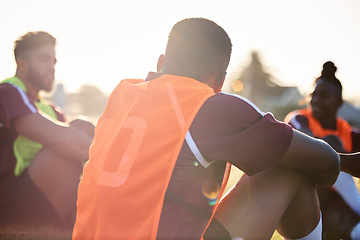 Image showing Group, rugby and men relax on field outdoor, talking and communication at sunrise in the morning. Sports, athlete team and players sitting together after exercise, training or friends workout in game