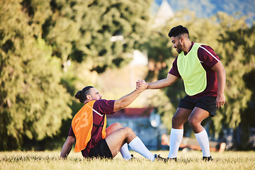 Image showing Rugby, teamwork and a sports man helping a friend while training together on a stadium field for fitness. Partnership, exercise and team building with an athlete and teammate outdoor for support